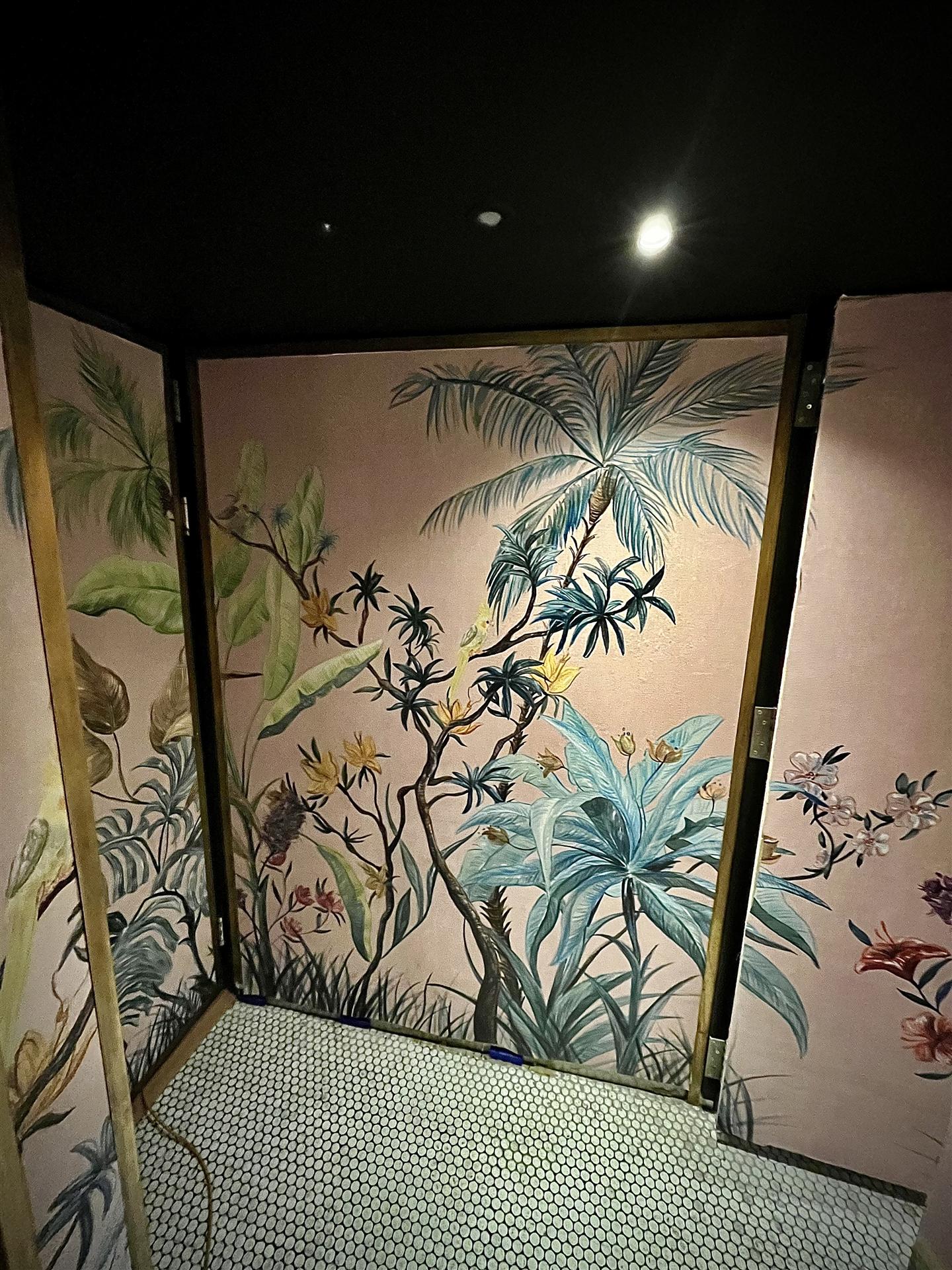 Pink botanical wallpaper in restaurant toilet cubicle, London